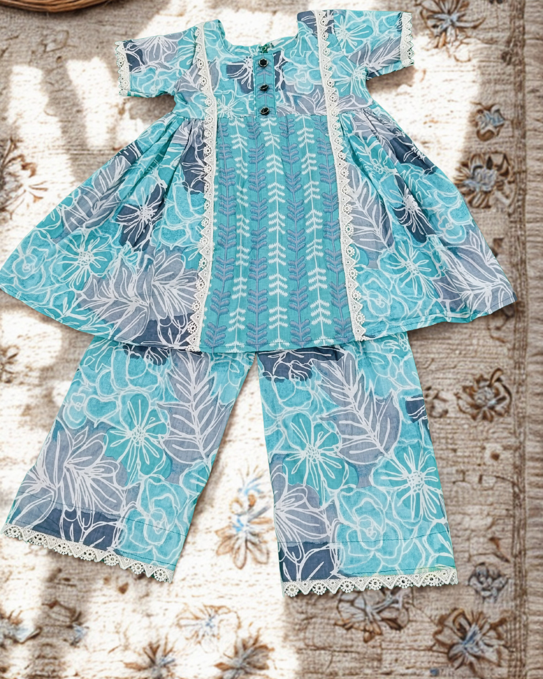 Flat lay teal blue floral cotton kurti and matching pants set