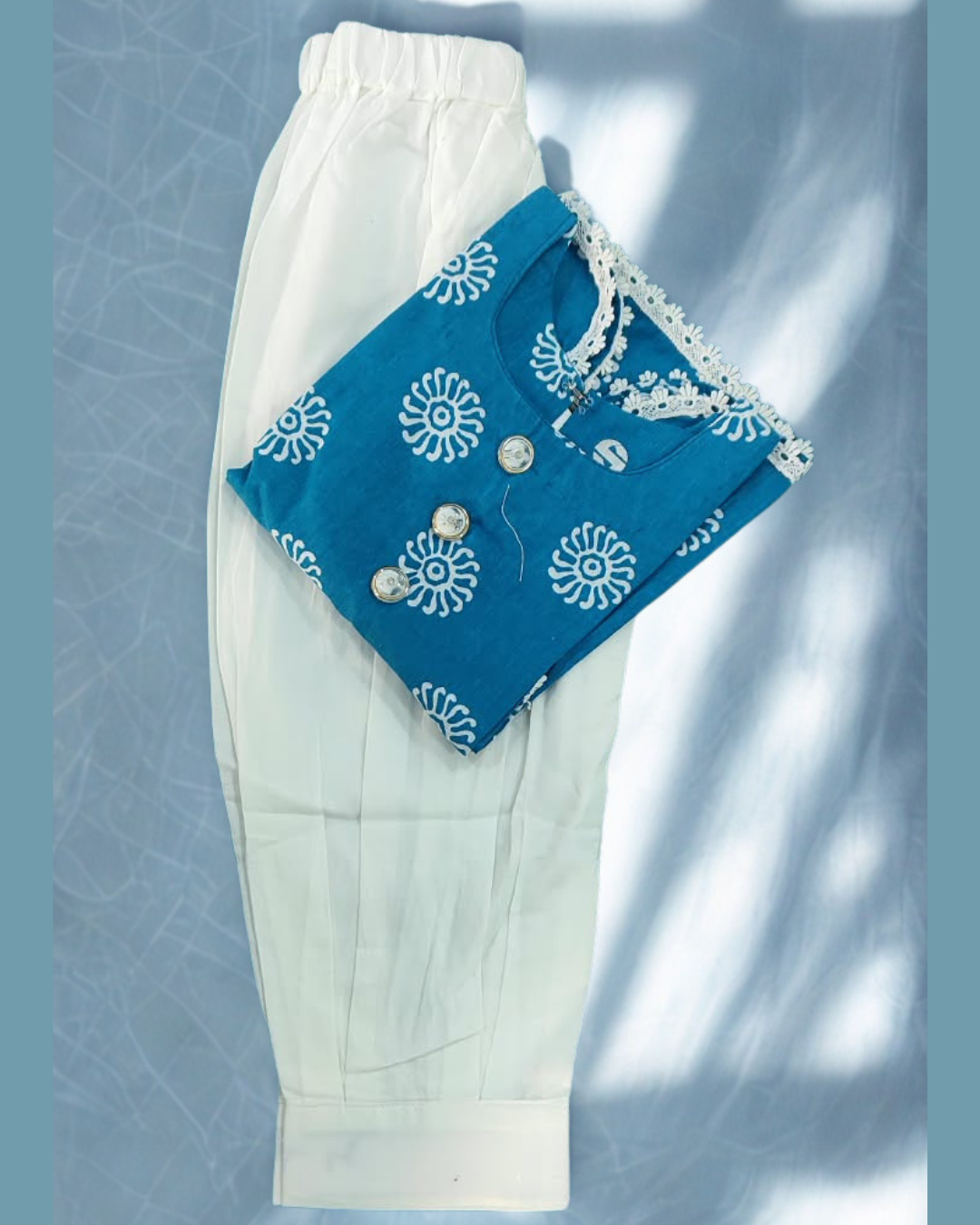 Aaftab baby girl kurti set, blue base, white sun-motif batik print - folded