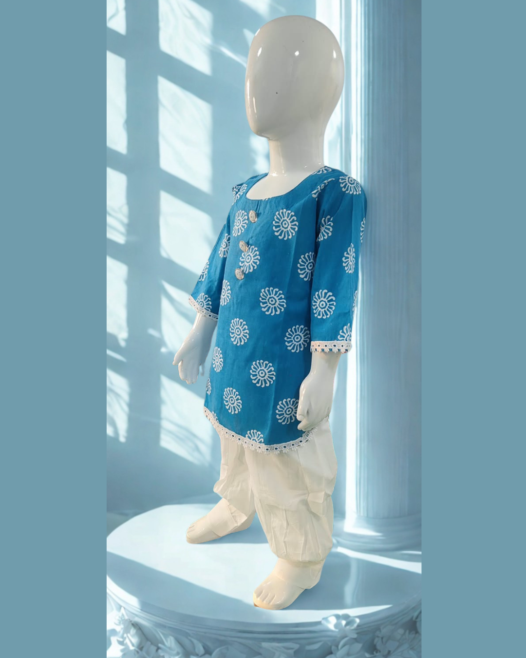 Aaftab baby girl kurti set, blue base, white sun-motif batik print - side view