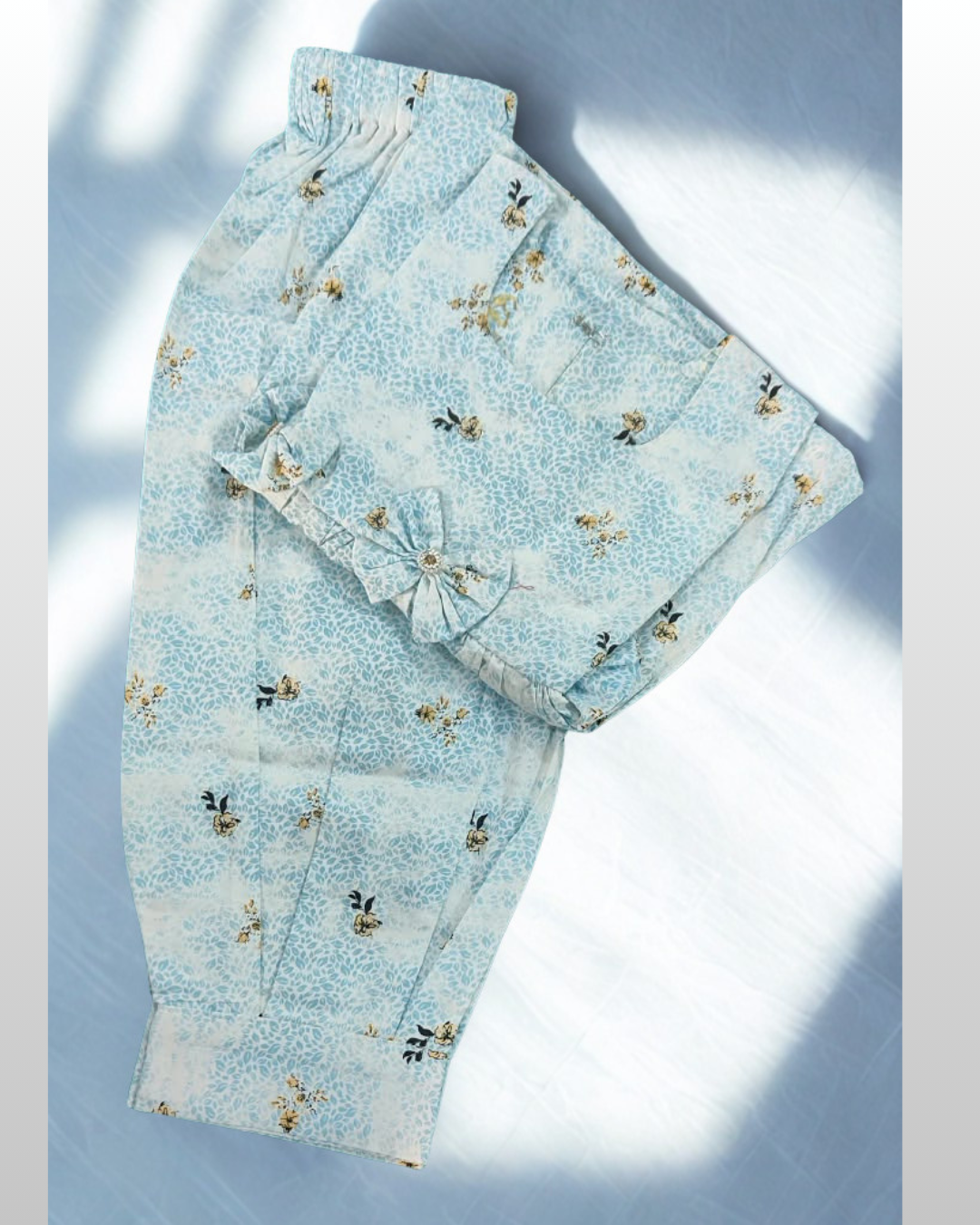 Asman baby girl kurti set, sky-blue and white base, small yellow floral print, sleeveless, gathered waist, 3 bows, matching pants - folded
