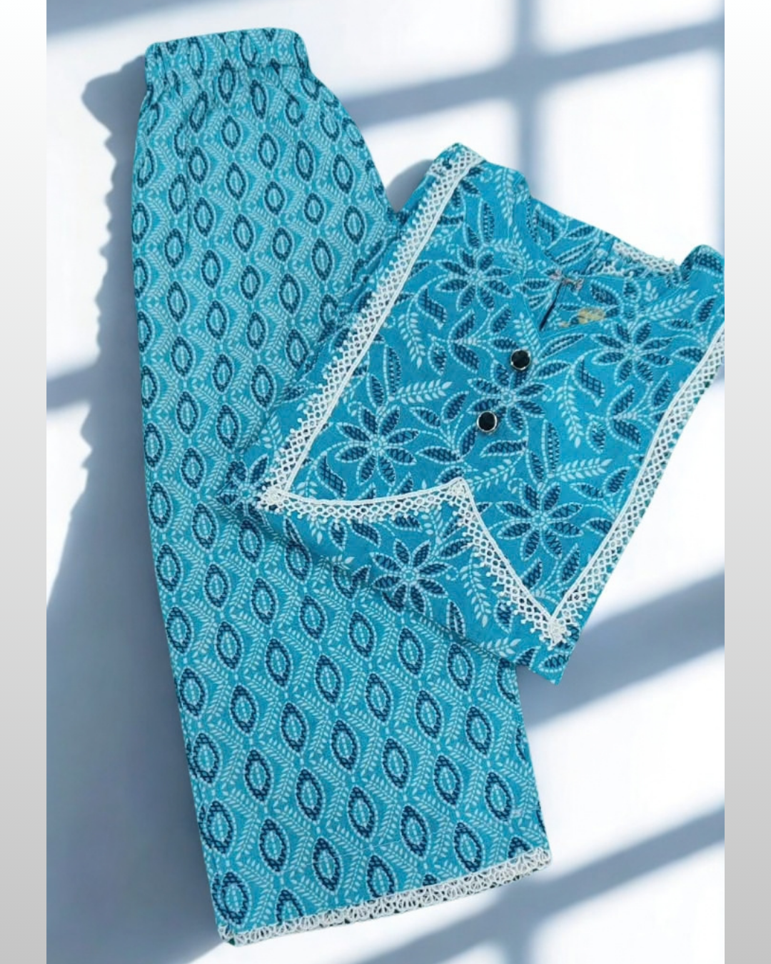 Firoza baby girl kurti set, teal base, white floral print, white lace V-neckline, silver gota trim - folded