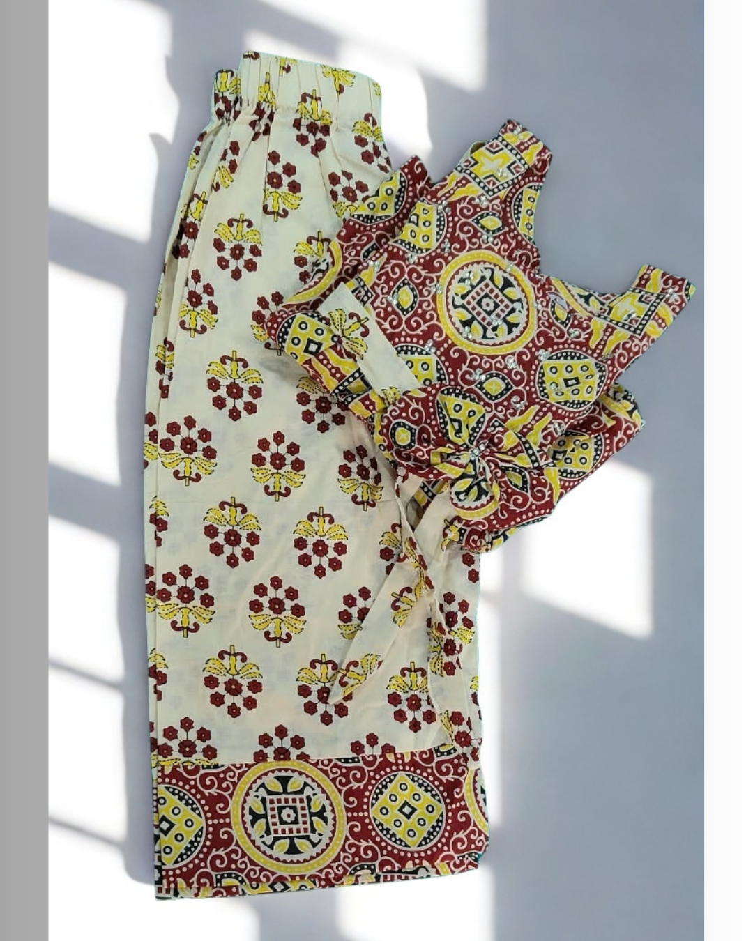 Gulnar baby girl kurti set, red and yellow on cream, bold geometric paisley print - folded