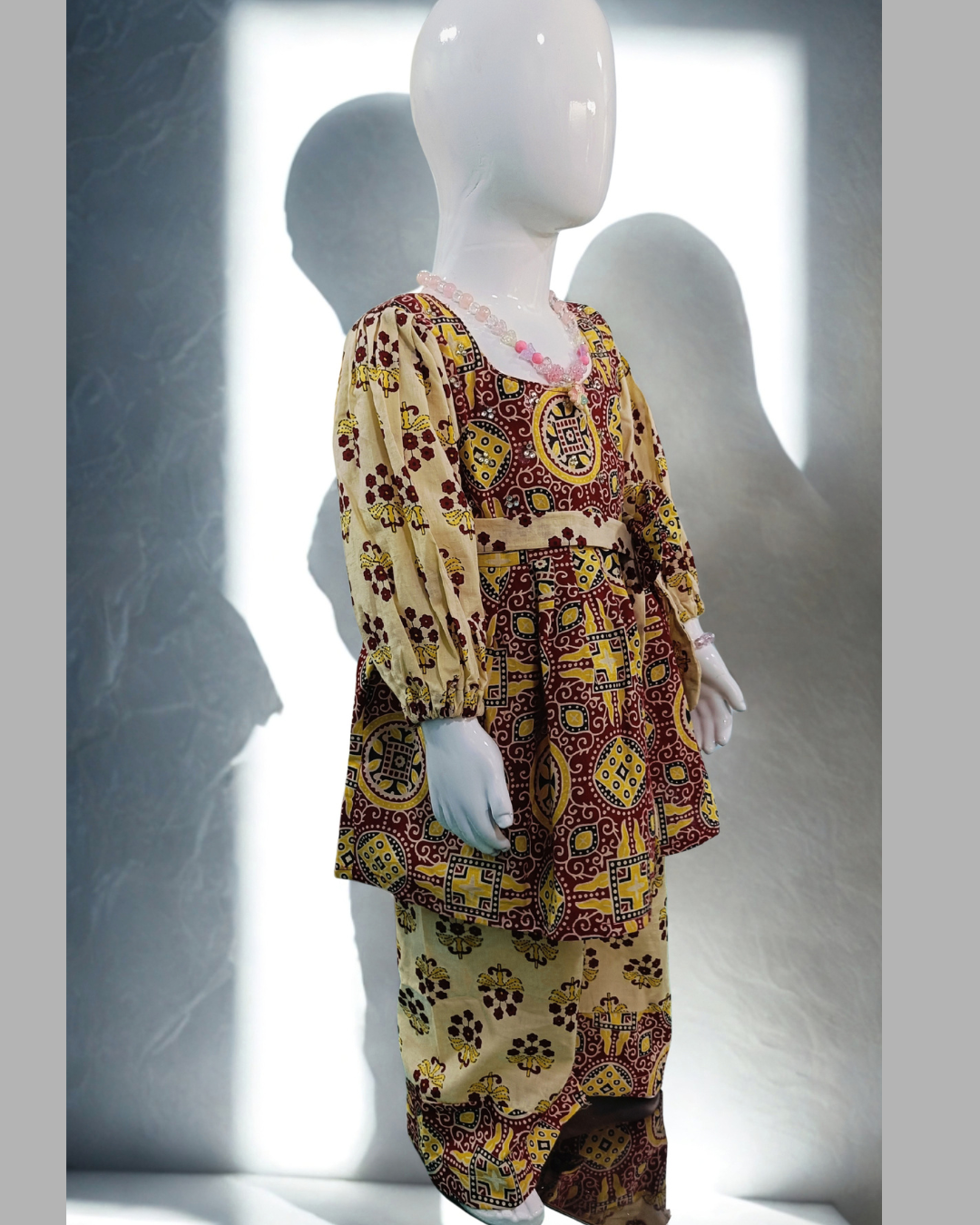 Gulnar baby girl kurti set, red and yellow on cream, bold geometric paisley print - side view