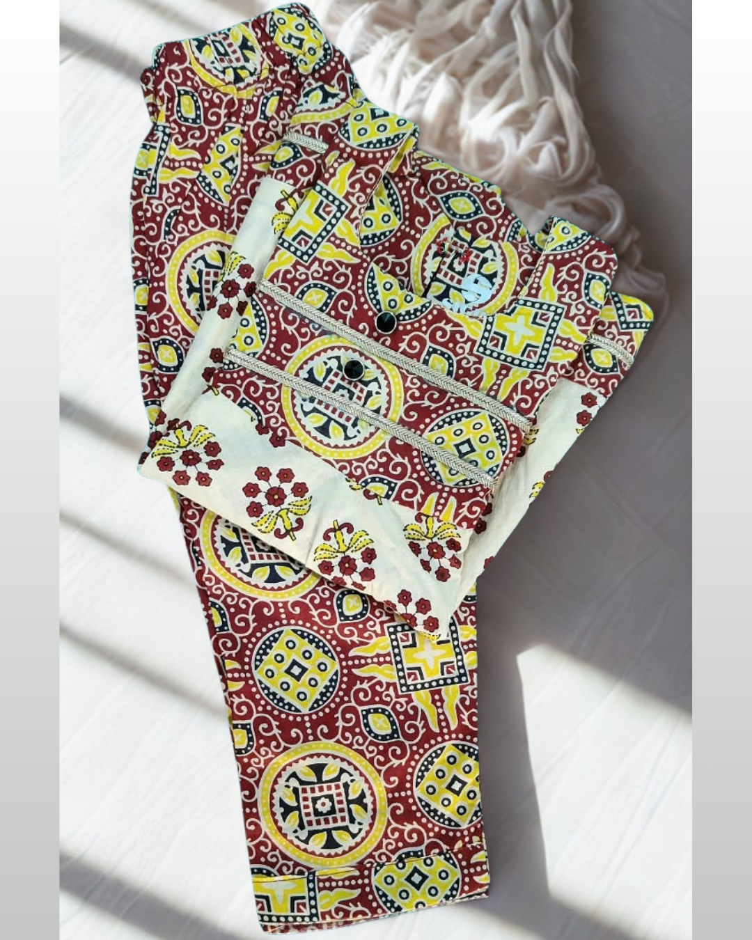 Kesari baby girl kurti set, cream base, red/yellow bold ajrakh geometric print, gold gota trim - folded