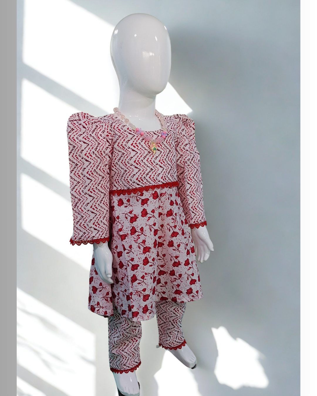 Laal Pari baby girl kurti set, white base, red abstract zigzag and floral print, red lace at waist - front view