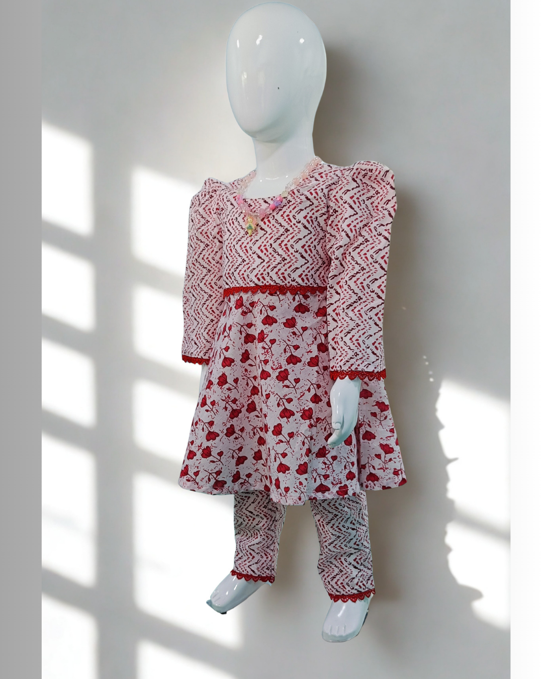Laal Pari baby girl kurti set, white base, red abstract zigzag and floral print, red lace at waist - side view