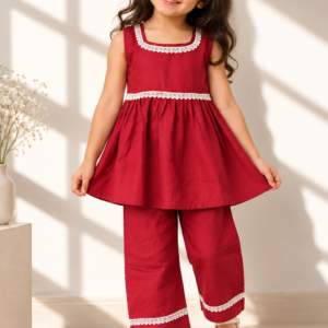 Laadli baby girl kurti set, crimson-maroon base, sleeveless, gathered waist, white lace on neckline, waist and pants hem - worn by a baby girl model