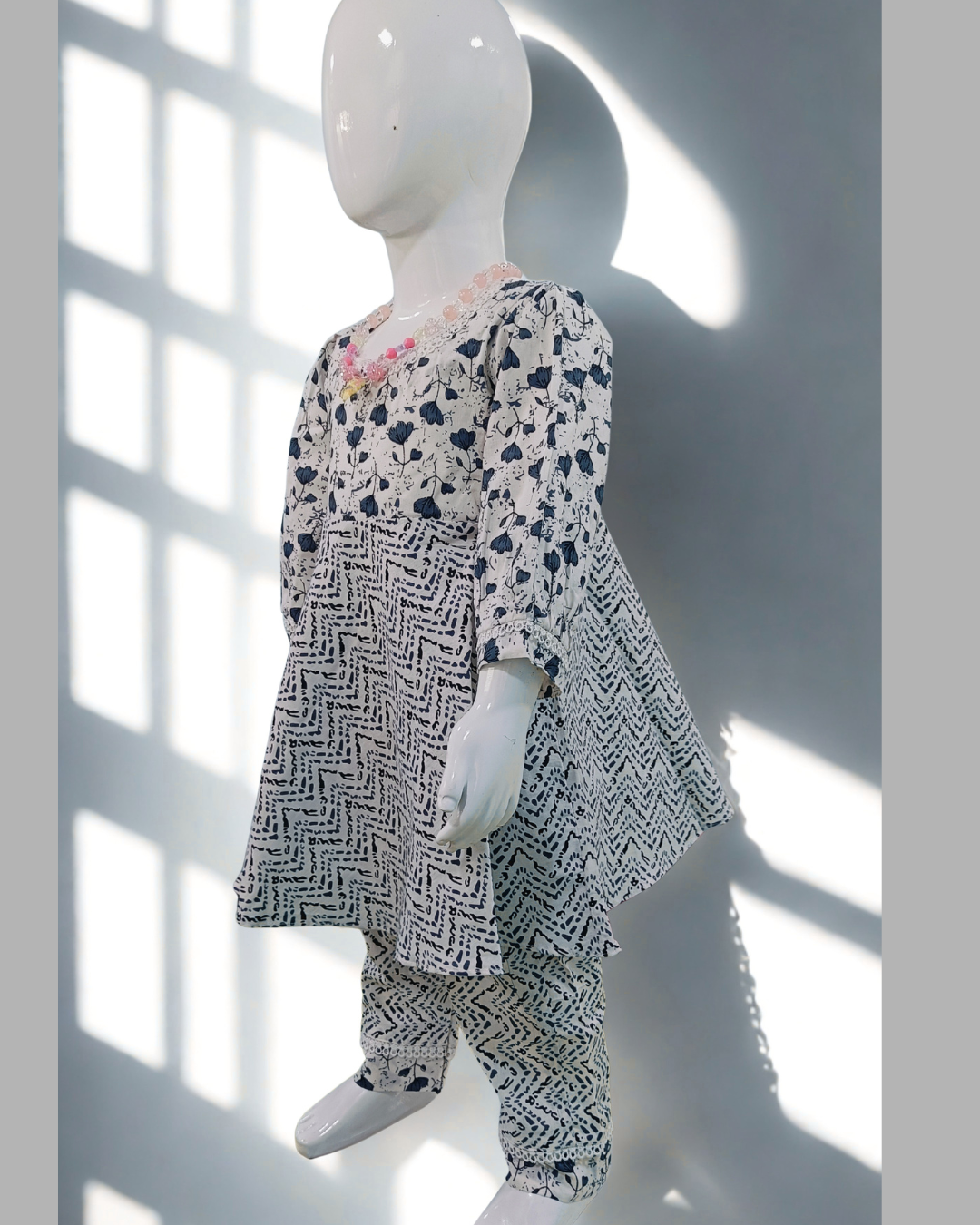 Marmar baby girl kurti set, cream base, pink floral print, white moti (pearl) detailing - front view