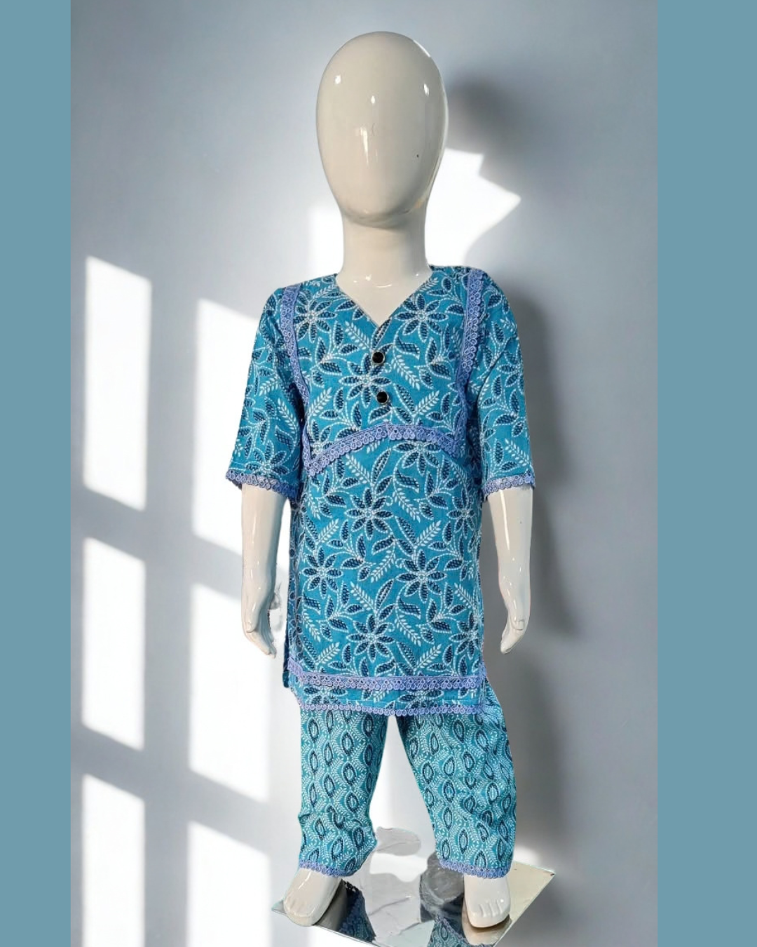 Neelam baby girl kurti set, blue base, dark blue leaf/floral print, blue lace, oval-print palazzo - front view
