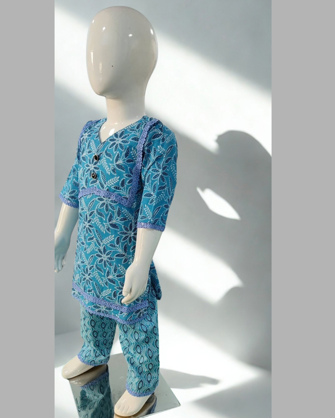 Neelam baby girl kurti set, blue base, dark blue leaf/floral print, blue lace, oval-print palazzo - side view