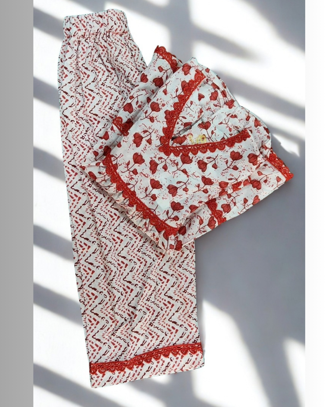 Rani baby girl kurti set, white base, small red floral print, red lace neckline - folded