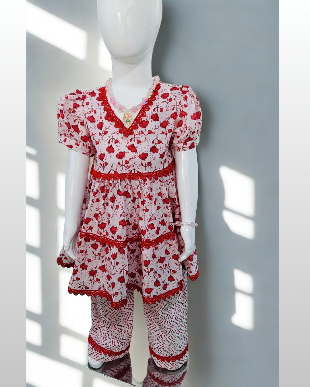 Rani baby girl kurti set, white base, small red floral print, red lace neckline - front view