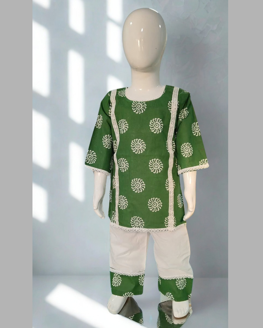 Sabza baby girl kurti set, deep green base, white mandala circle print, white lace, white palazzo - front view