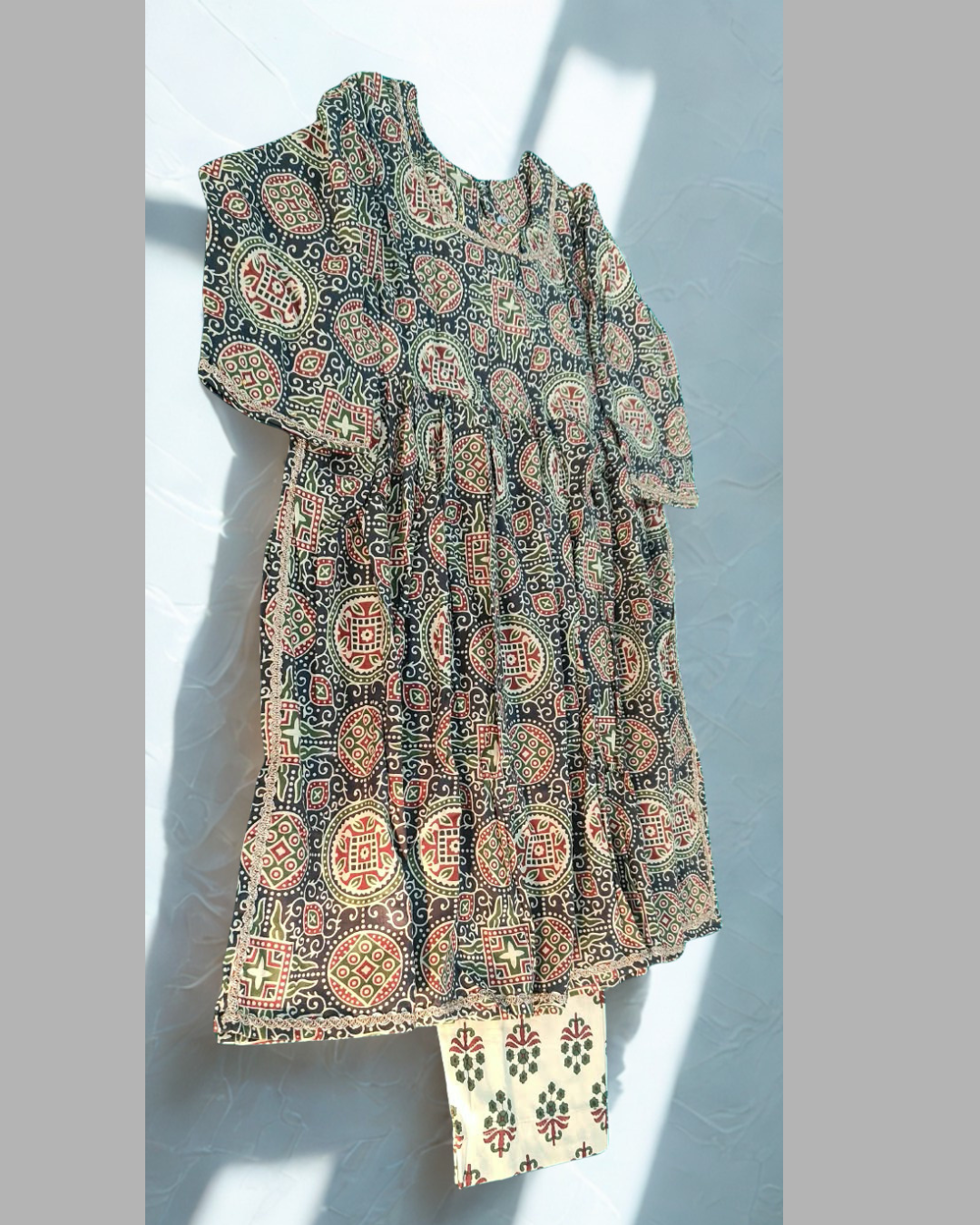 Shabnoor baby girl kurti set, black base, ajrakh print, lace trim - side view