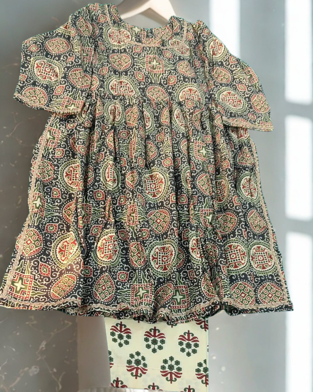 Shabnoor baby girl kurti set, black base, ajrakh print, lace trim - front view