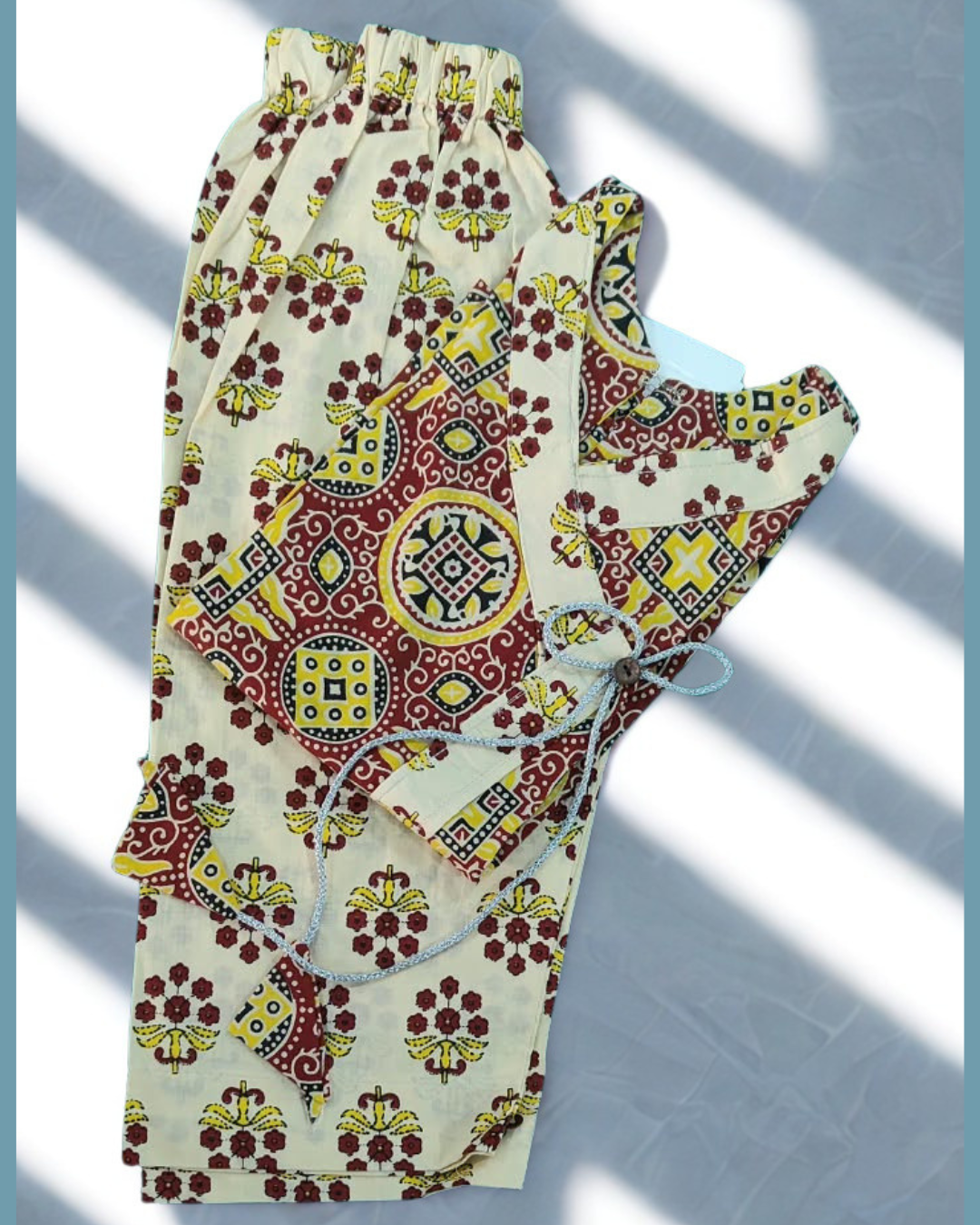 Shahzadi baby girl kurti set, white base, red floral print, front pocket, button detailing - folded