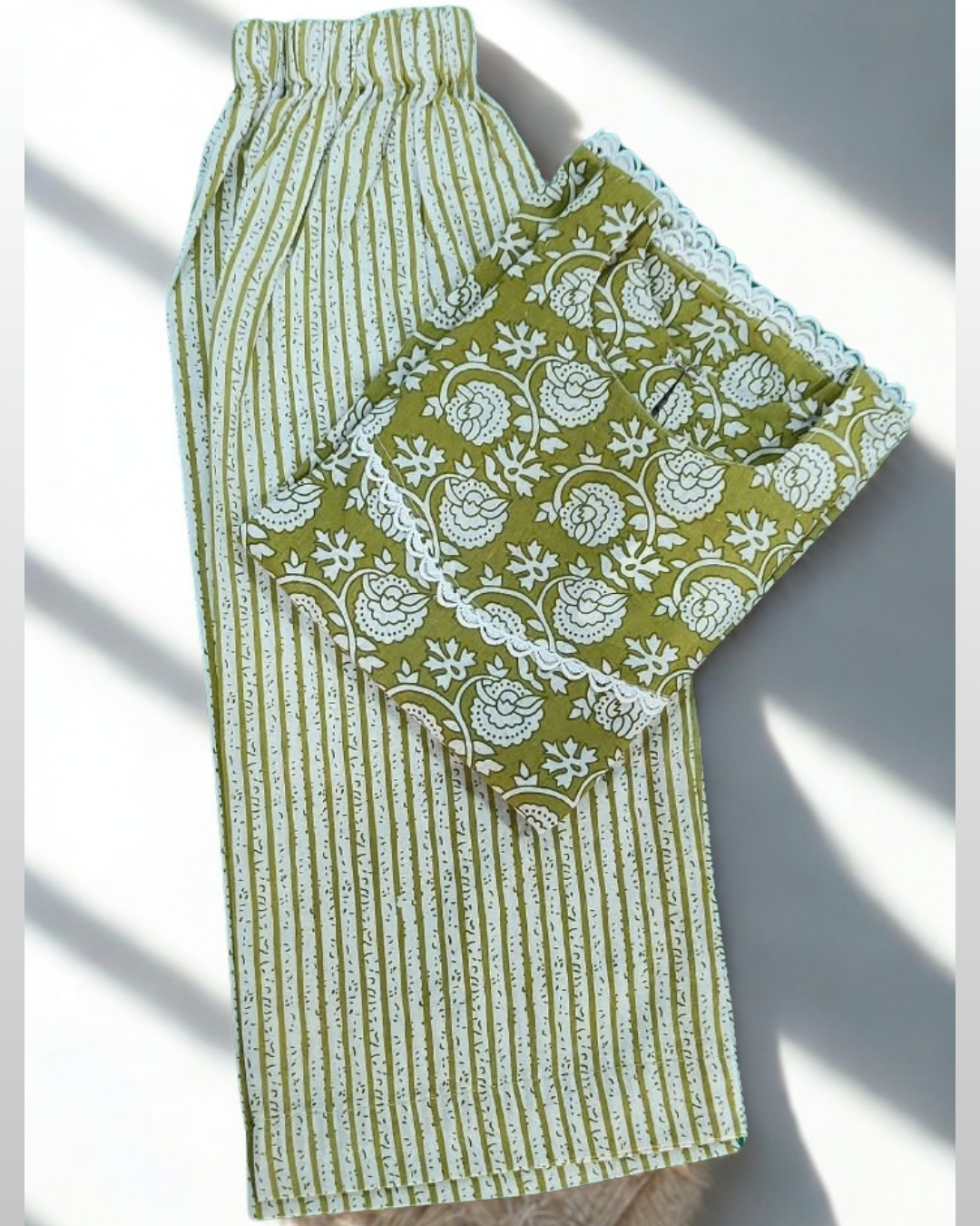 Sitara baby girl kurti set, olive green base, white stripe pattern, white lace trim - folded
