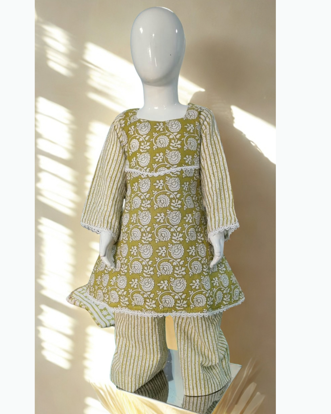 Sitara baby girl kurti set, olive green base, white stripe pattern, white lace trim - front view