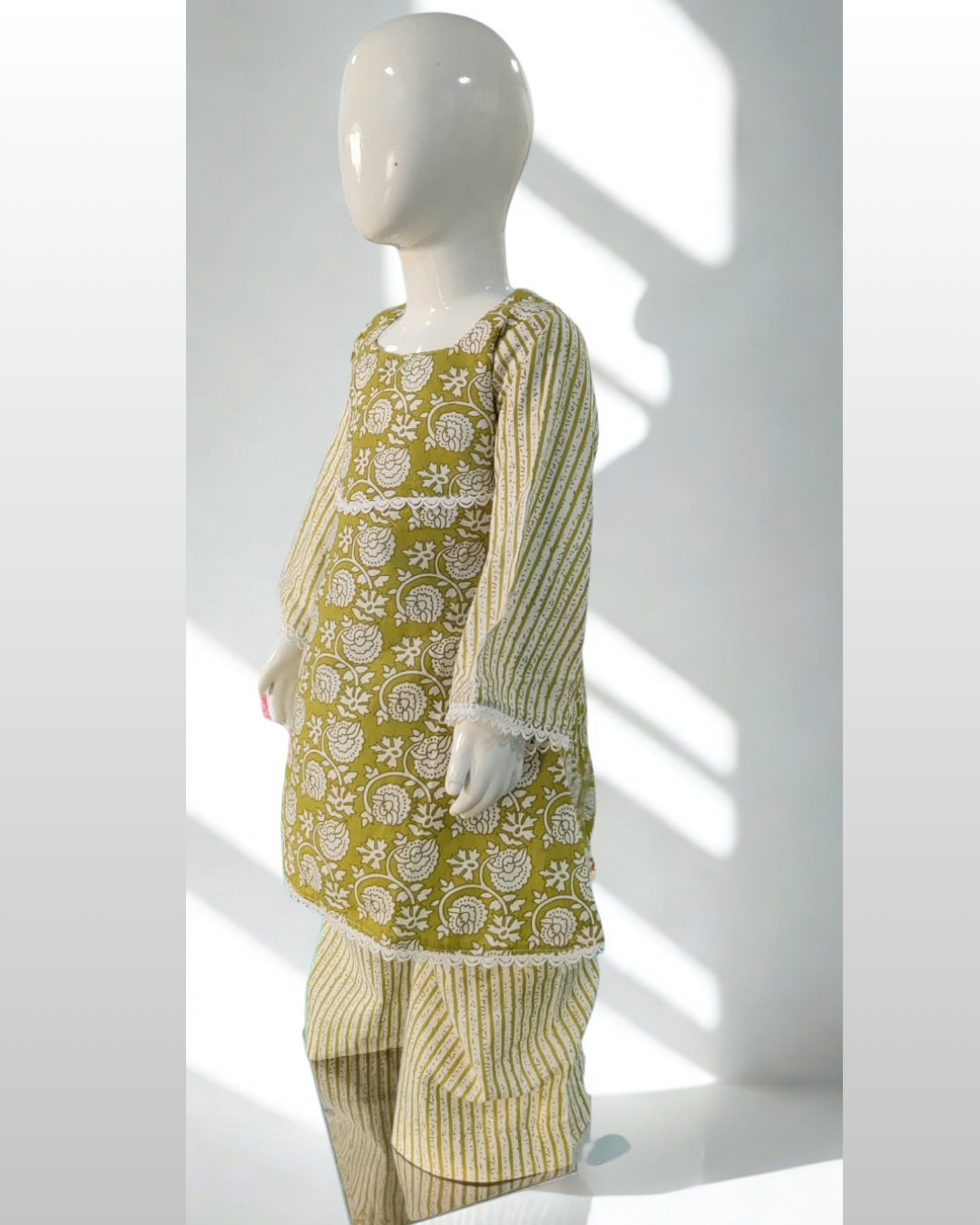 Sitara baby girl kurti set, olive green base, white stripe pattern, white lace trim - side view
