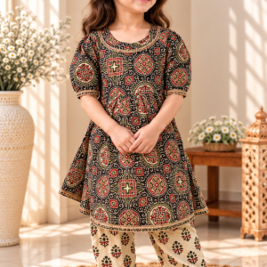 Sultana baby girl kurti set, black base, bold ajrakh paisley print, gold trim, cream mandala-print palazzo - worn by a baby girl model
