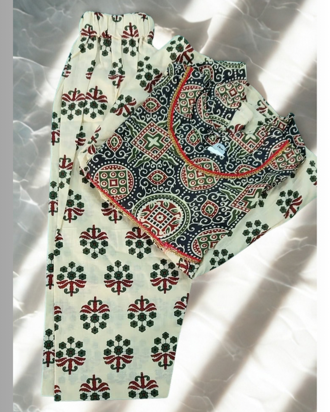 Zardozi baby girl kurti set, black base, bold ajrakh paisley print, red neckline trim - folded